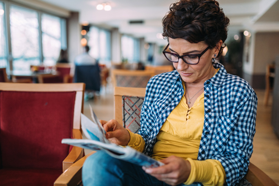 Femme lisant un magazine papier